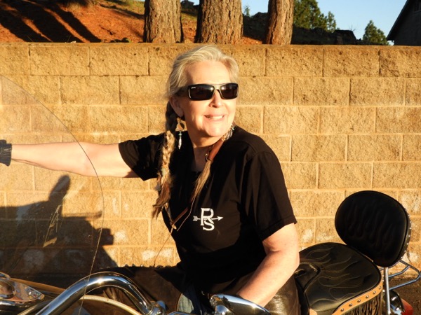 Female model smiling on motorcycle